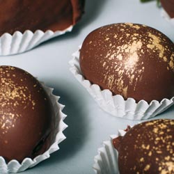 A tray of chocolate covered eggs.