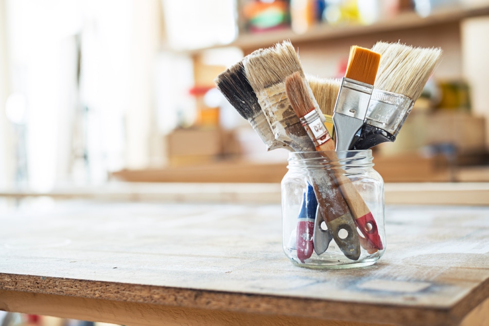 Paint brushes on the table in a workshop.