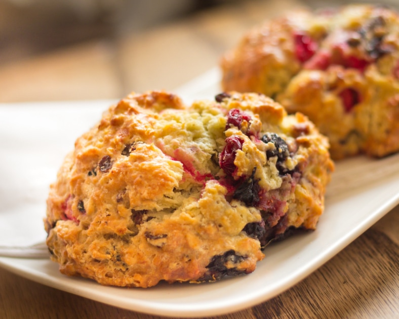 Warm cranberry scones on plate.