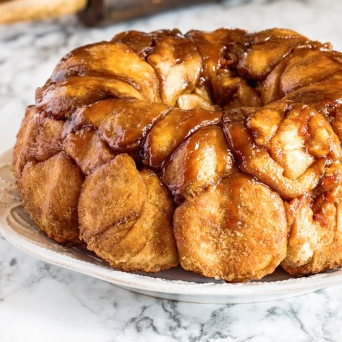 Easter dessert of Pull Apart Carrot Cake Monkey Bread. A yeast bundt cake made with cinnamon, carrots, nuts and a brown sugar glaze. Selective focus with blurred foreground and background.