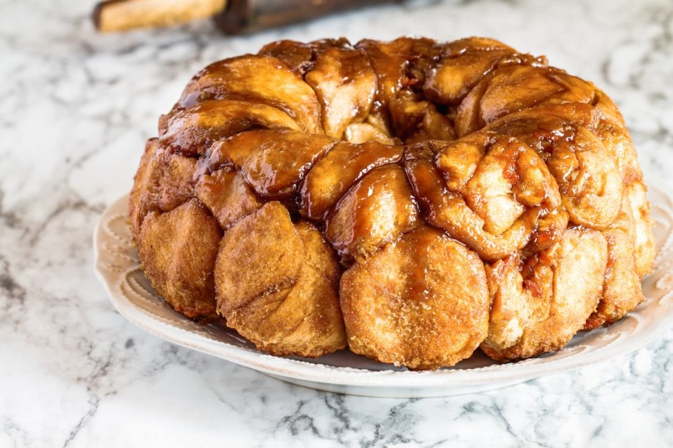 Easter dessert of Pull Apart Carrot Cake Monkey Bread. A yeast bundt cake made with cinnamon, carrots, nuts and a brown sugar glaze. Selective focus with blurred foreground and background.