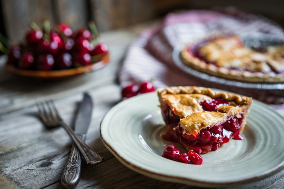 Homemade cherry pie on rustic background.