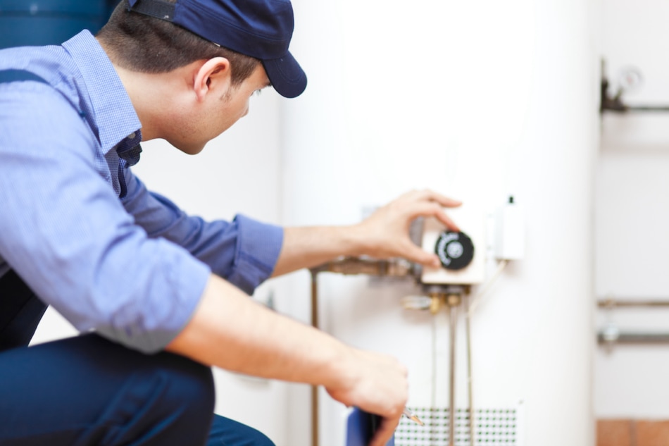 Plumber repairing an hot-water heater.