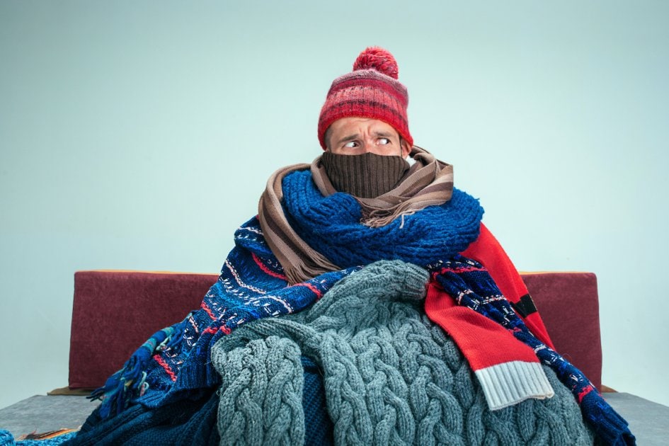 Bearded Man with Blue Sitting on Sofa at Home.