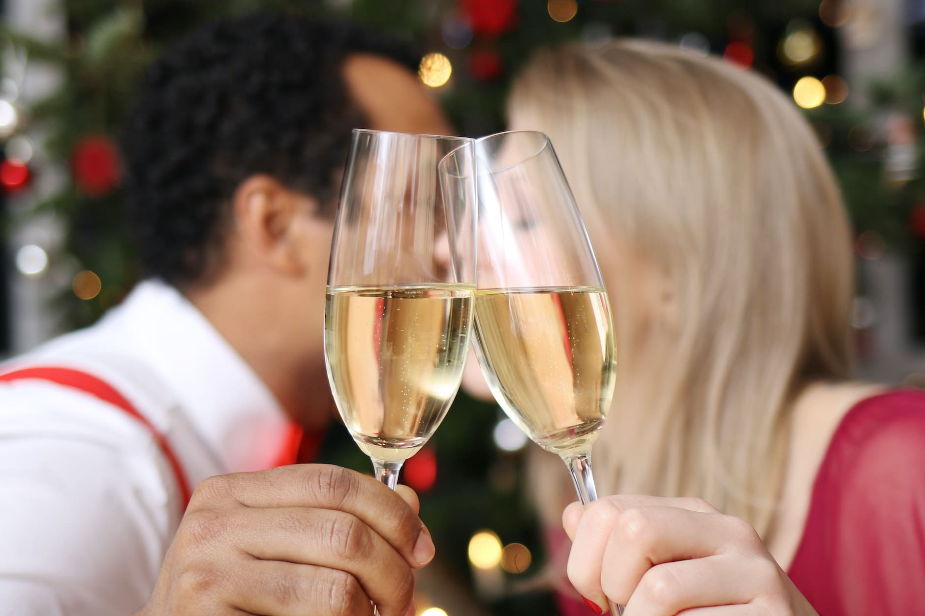 A couple kissing at midnight on New Year's Eve, the first of the New Year's superstitions and traditions
