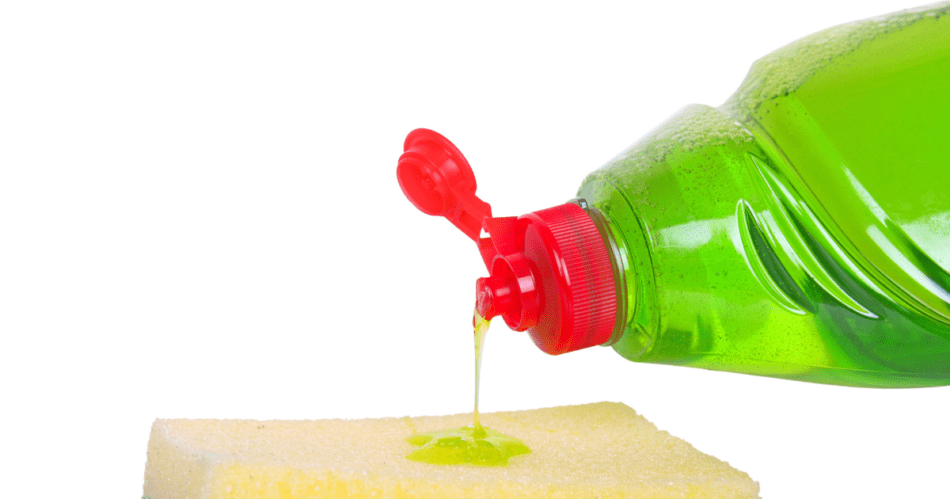 Green liquid dish soap poured onto a sponge.