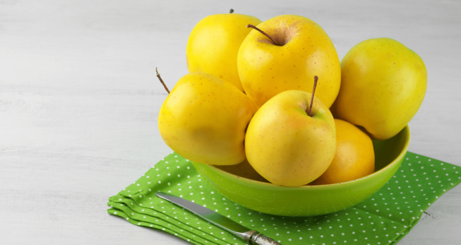 Golden delicious apples in a bowl.