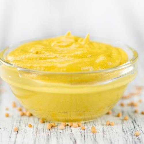 Yellow mustard in glass bowl.