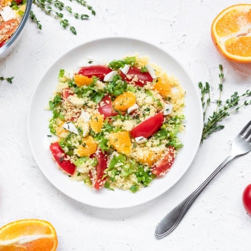 Healthy and simple food, light summer lunch, fragrant salad with couscous and oranges.