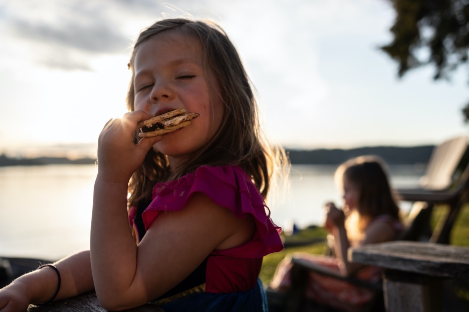 Young girl eating s'mores.