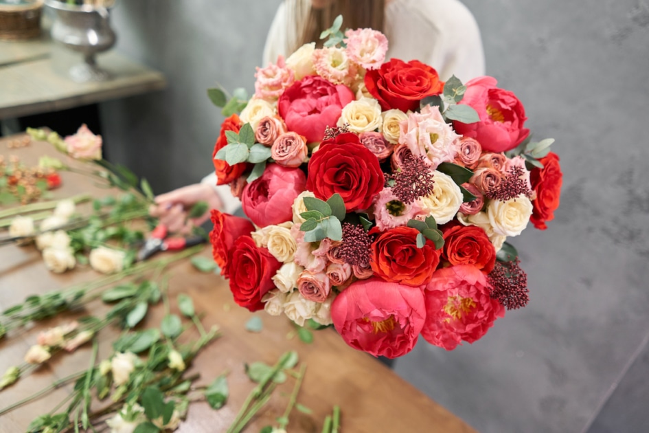 Valentine's bouquet with red, pink, and cream colored flowers.