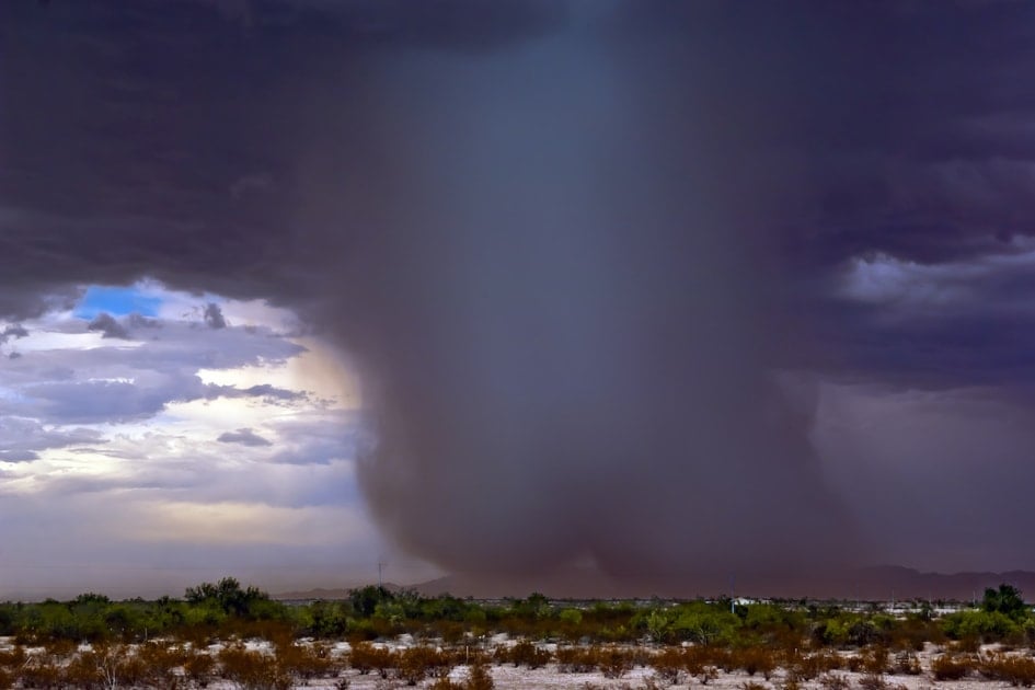 A very dense shaft of rain falling from a microburst storm.