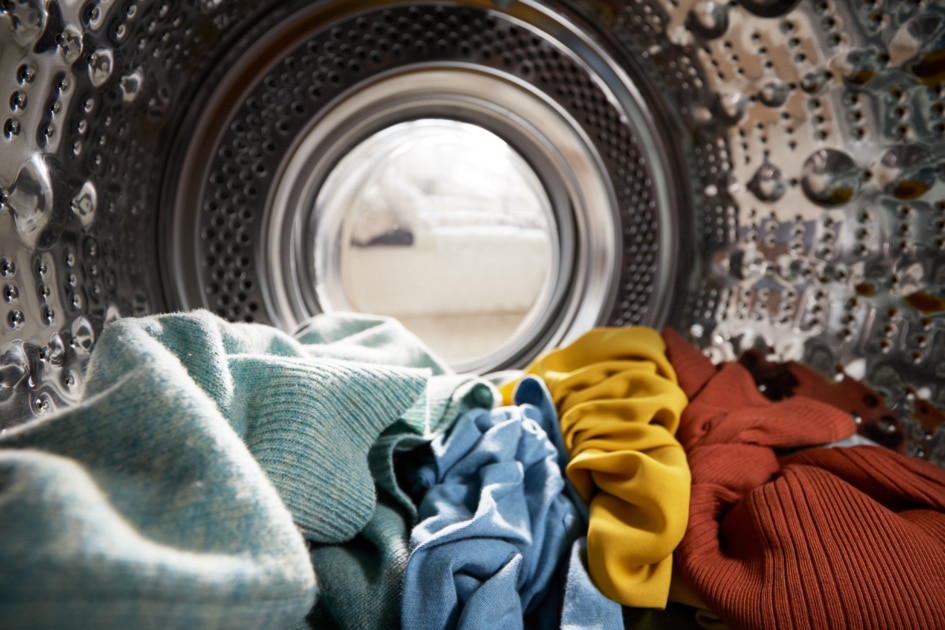 View Looking Out From Inside Washing Machine Filled With Laundry.