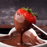 Fondue with Melting chocolate or melted chocolate and strawberry.