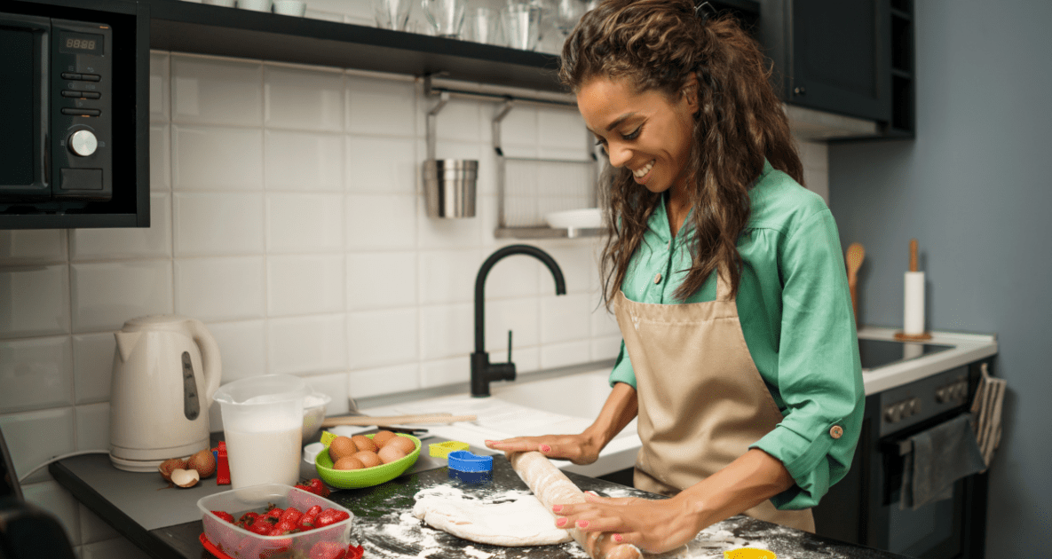 woman rolling pie crust on the counter.