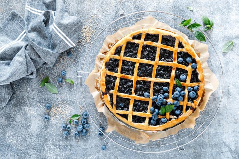 Traditional homemade american blueberry pie with lattice pastry, top view.