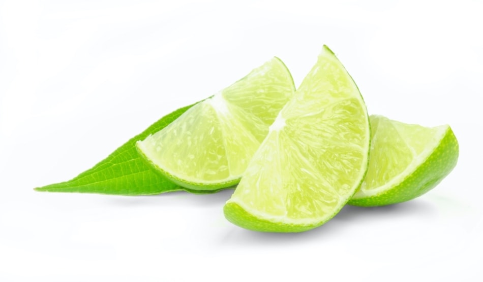Fresh lime wedges isolated on a white background.