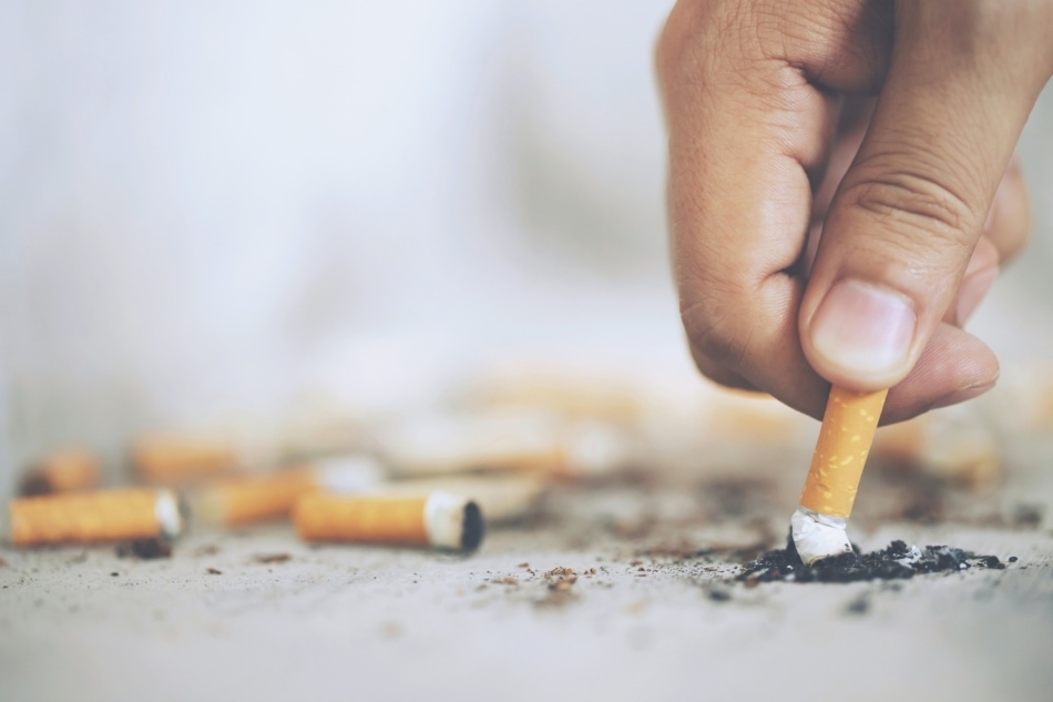 Hand putting out a cigarette.