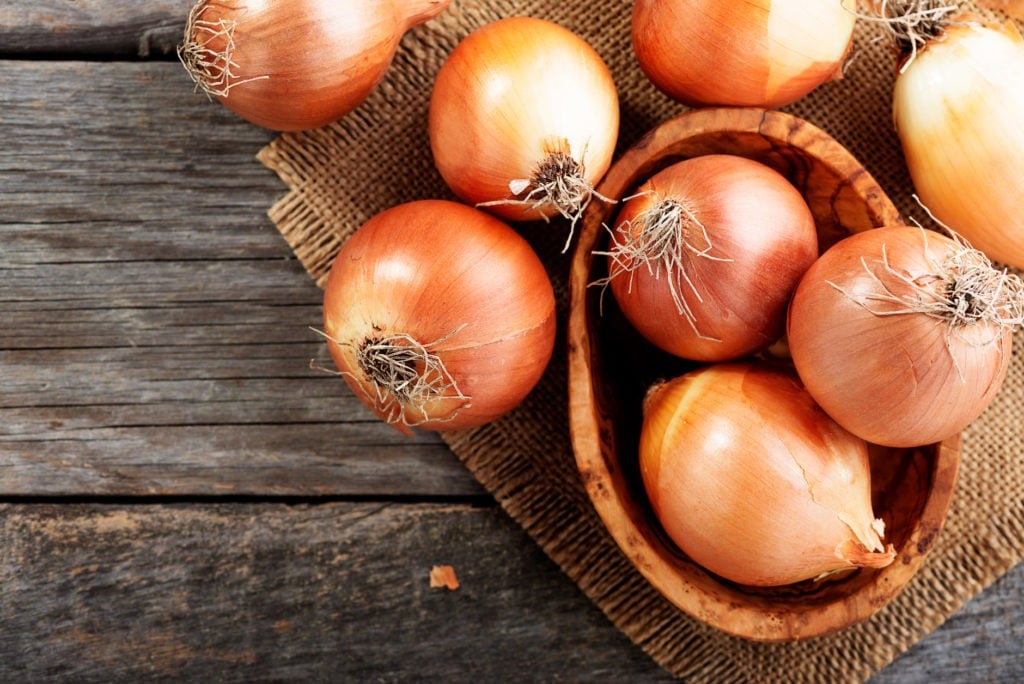 Loose onions on a wooden table