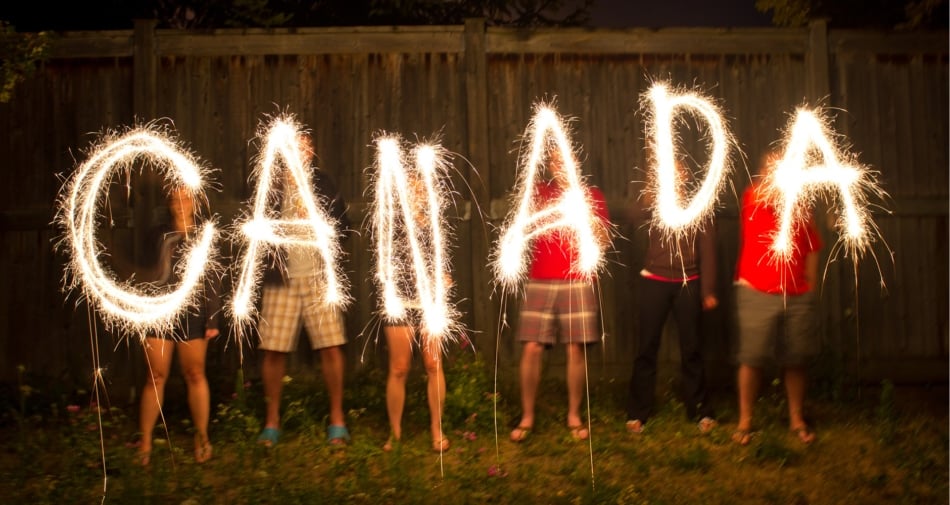 Children spelling out CANADA using sparklers.
