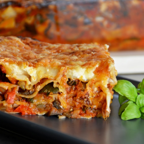 Zucchini lasagna on a plate with basil.