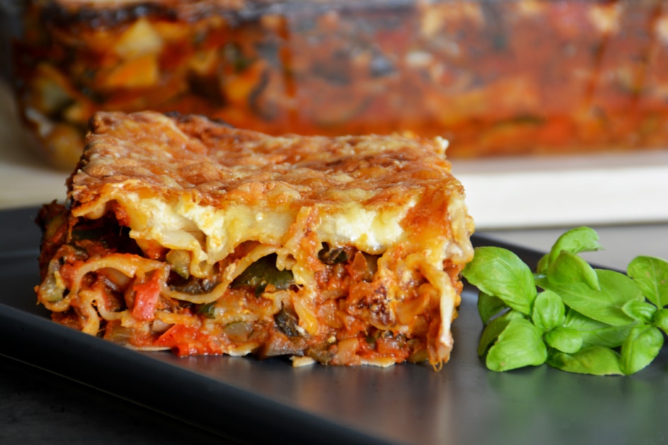 Zucchini lasagna on a plate with basil.