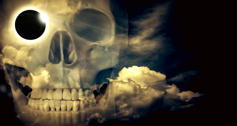 Closeup of a transparent skull with haunting skies in background.