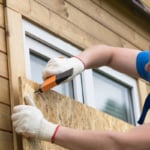 Man blocking the windows before a natural disaster.