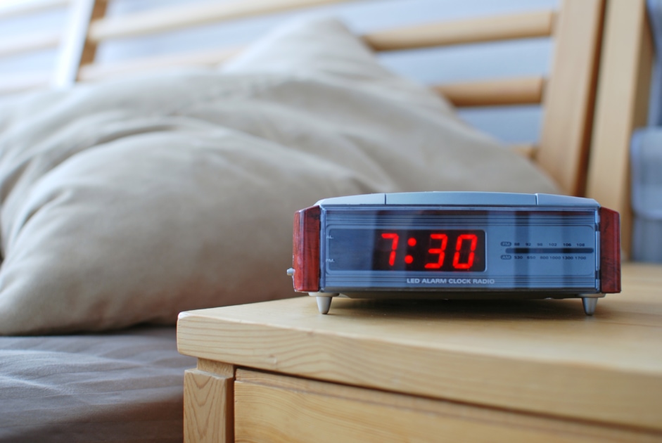 digital clock at bedside on nightstand