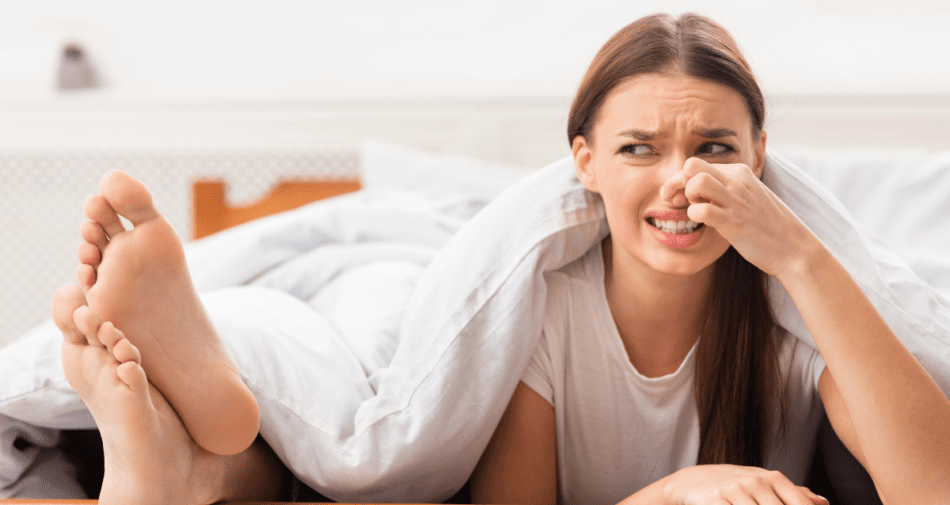 woman holding nose for smelly feet.