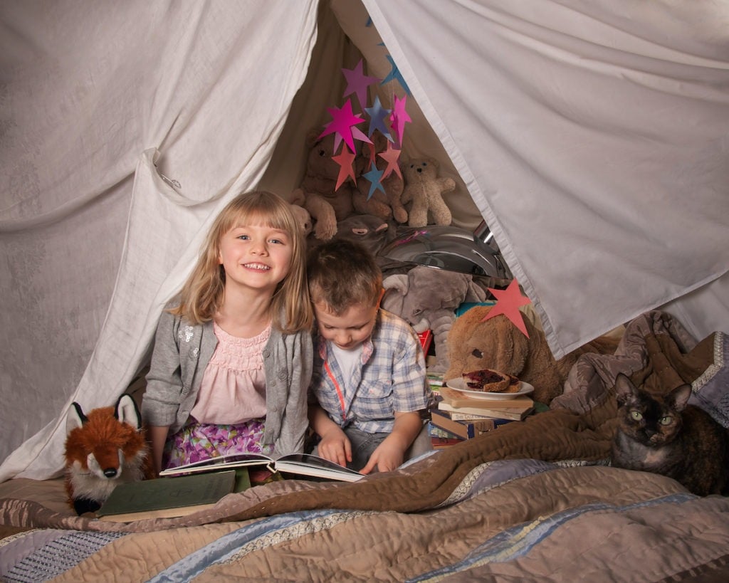 girl and boy in a fort livingroom