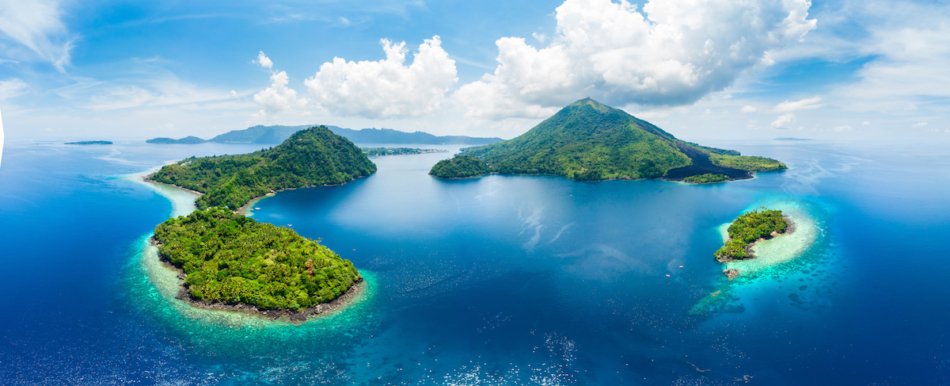 Aerial view Banda Islands Moluccas archipelago Indonesia, Pulau Gunung Api, lava flows, coral reef white sand beach. Top travel tourist destination, best diving snorkeling.