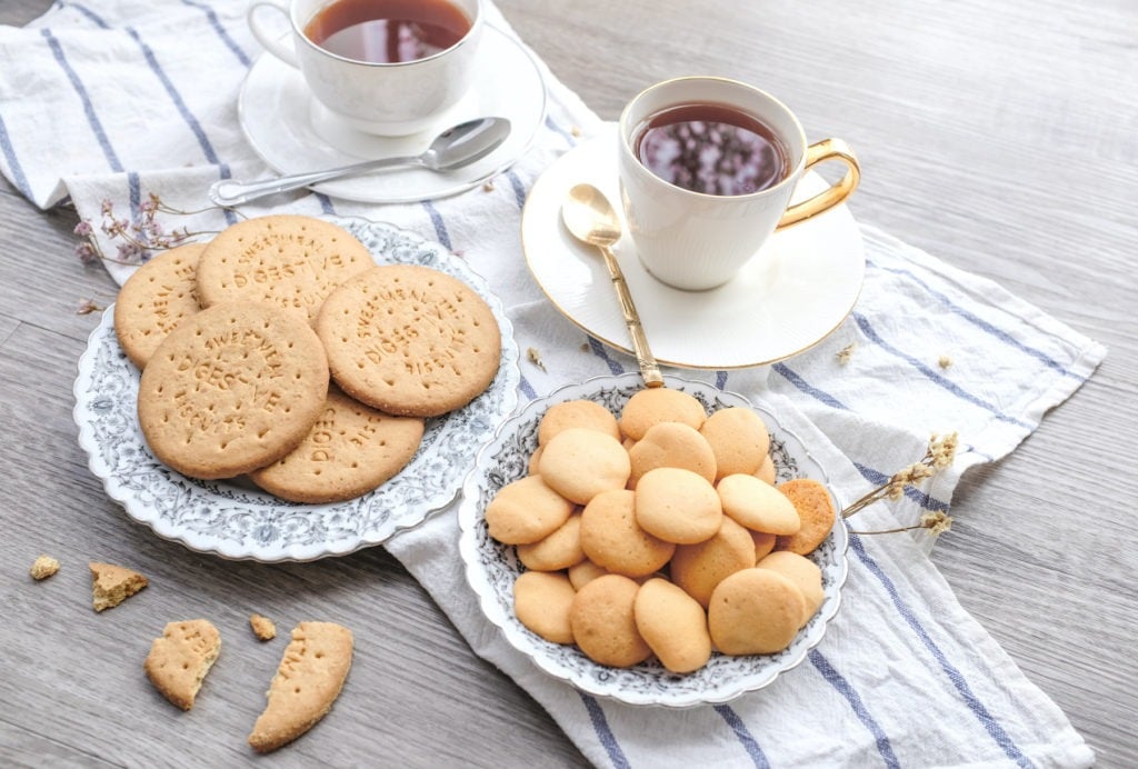 cookies and biscuits on a table with tea and tea towels