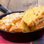 Freshly baked corn bread in cast iron pan.