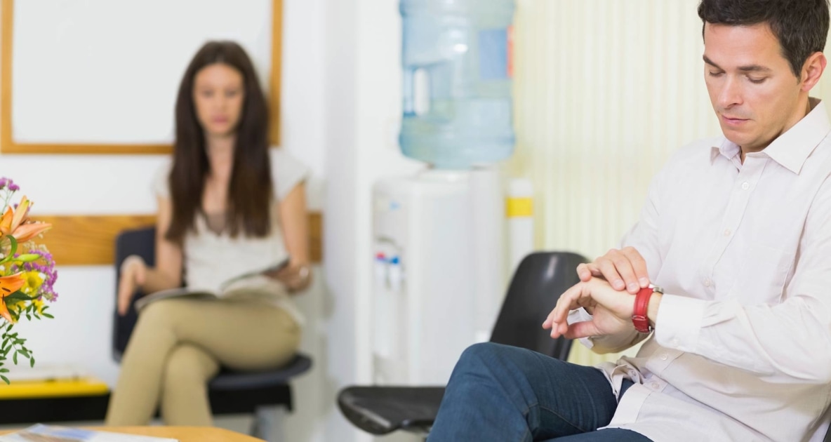 Man and a woman waiting at the doctor's office.