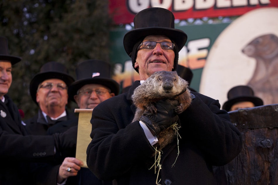 Mayor holds up Punxsutawney Phil during Groundhog Day in 2013.