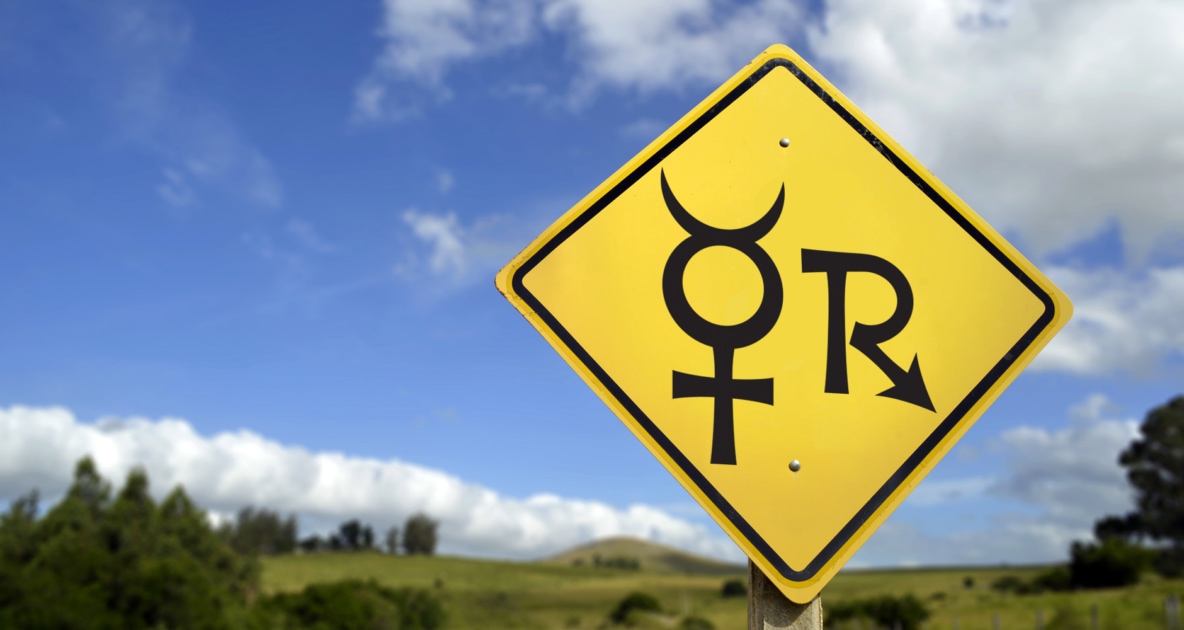 A yellow road sign with Mercury Retrograde symbols.