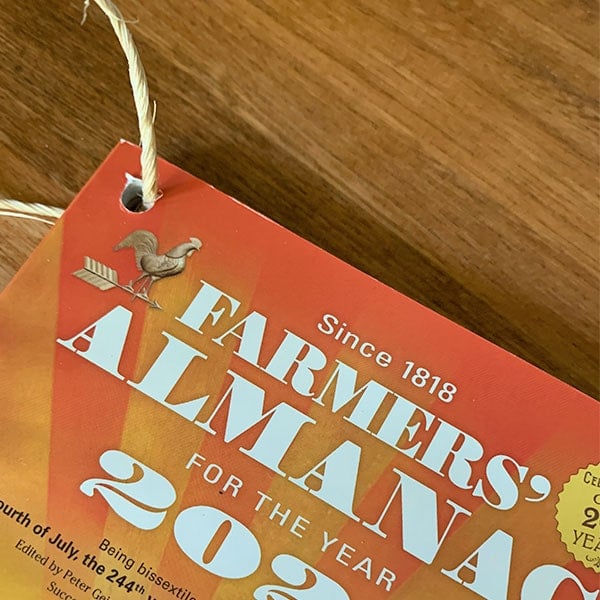 Hole in the Farmers' Almanac with a ring through it.