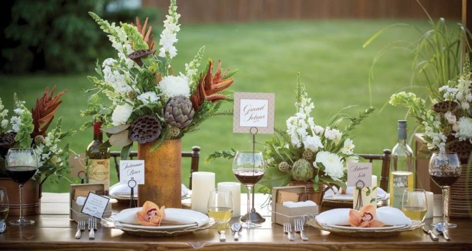 Wedding decorations and silverware on a table with a Grand Tetons card shown in the middle.