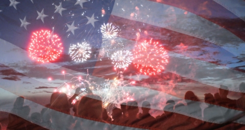 Crowd watching fireworks with a transparent image of the United States flag overlaid.