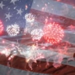 Crowd watching fireworks with a transparent image of the United States flag overlaid.