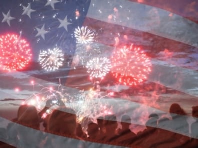 Crowd watching fireworks with a transparent image of the United States flag overlaid.