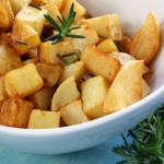 A bowl full of rosemary roasted potatoes ready to server