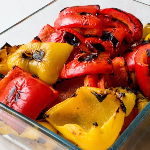 Grilled peppers in a glass dish.