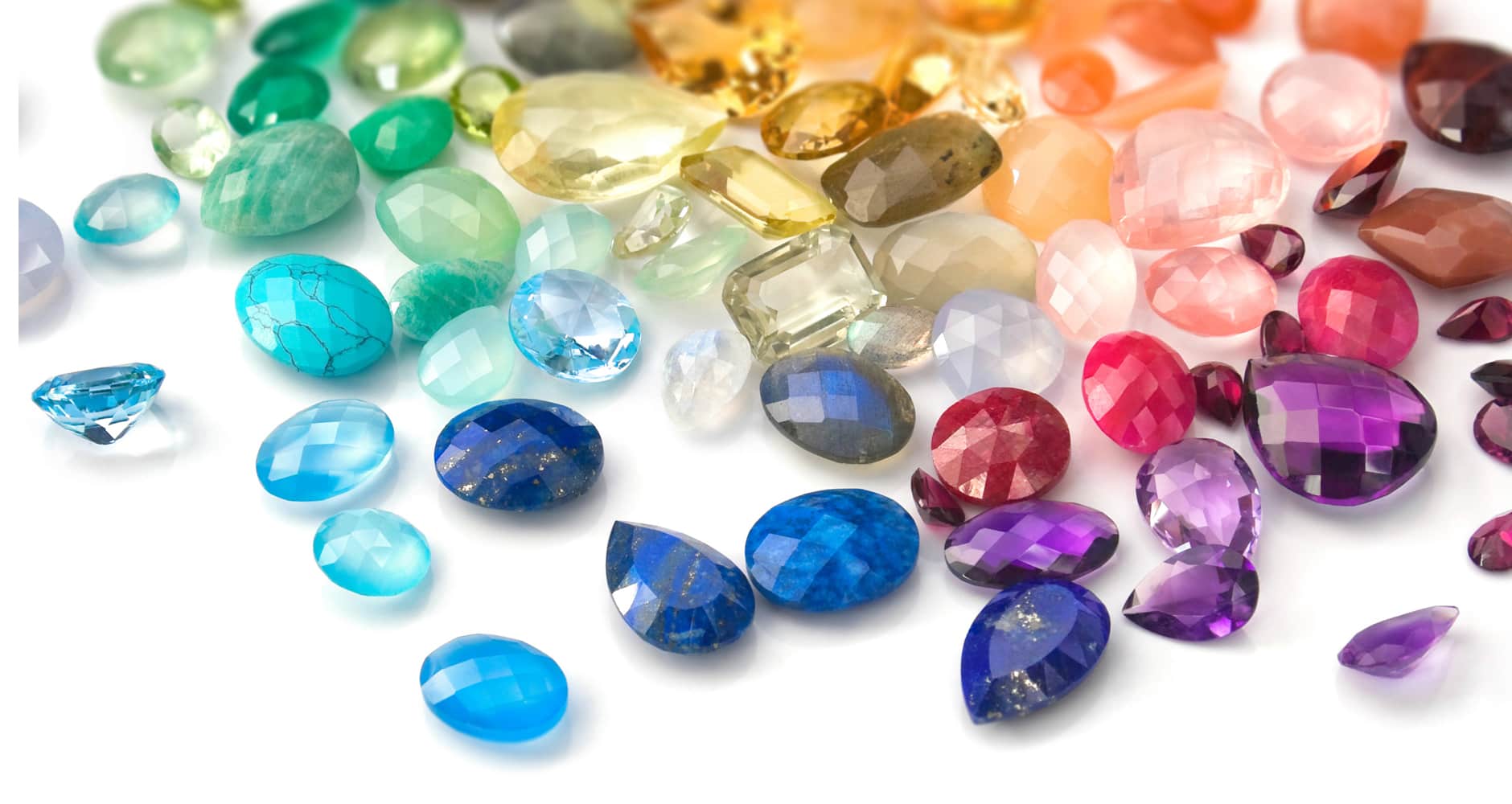 Collection of gemstones on white table