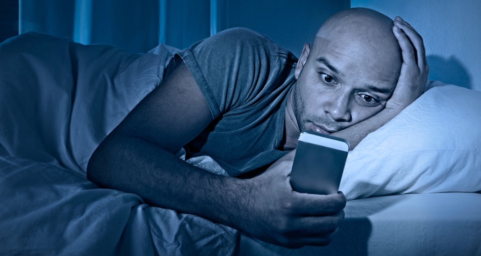 Sleep - Man with Smartphone in bed.