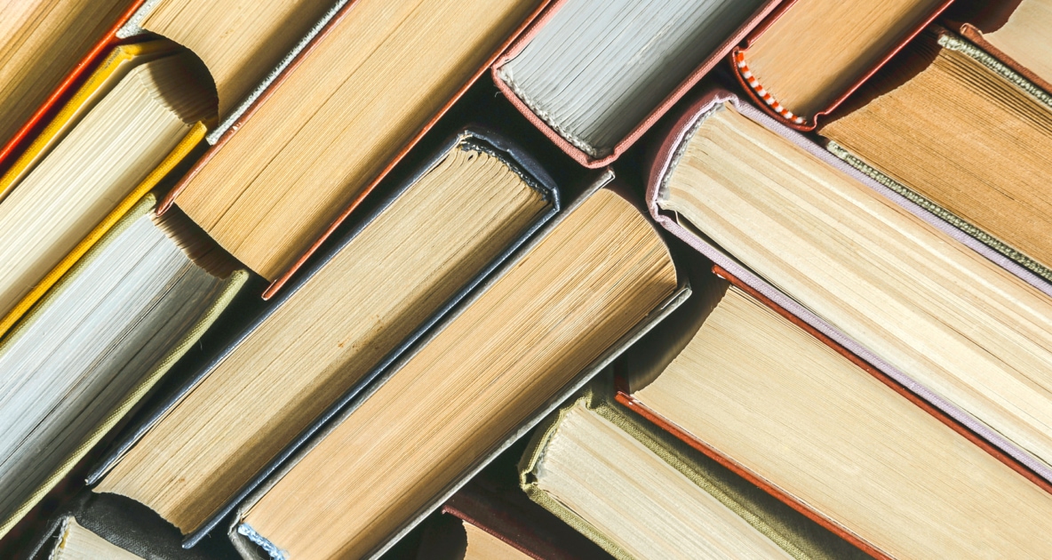 Bird's eye view of old books with aged paper.