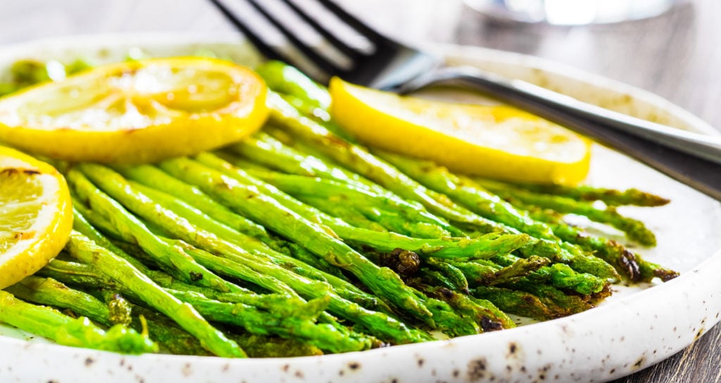 asparagus in a dish with lemon slices