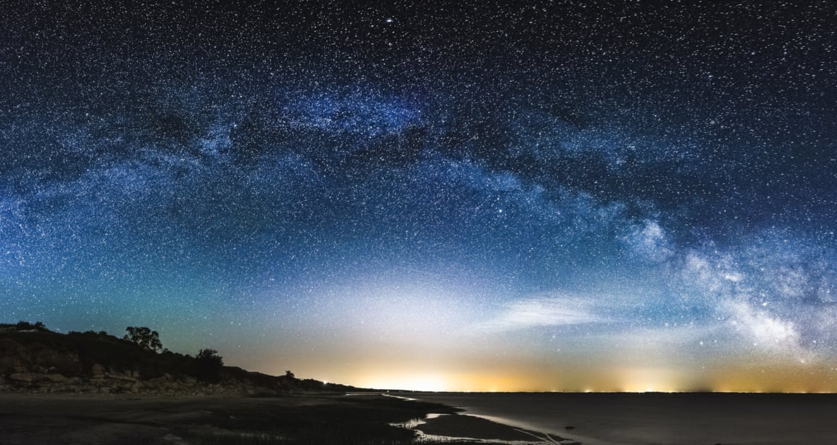 Milky Way Galaxy begins to appear over a setting sun.