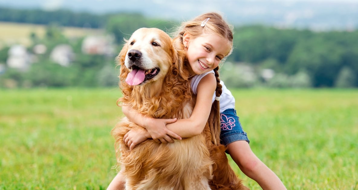 Young girl hugging her family dog